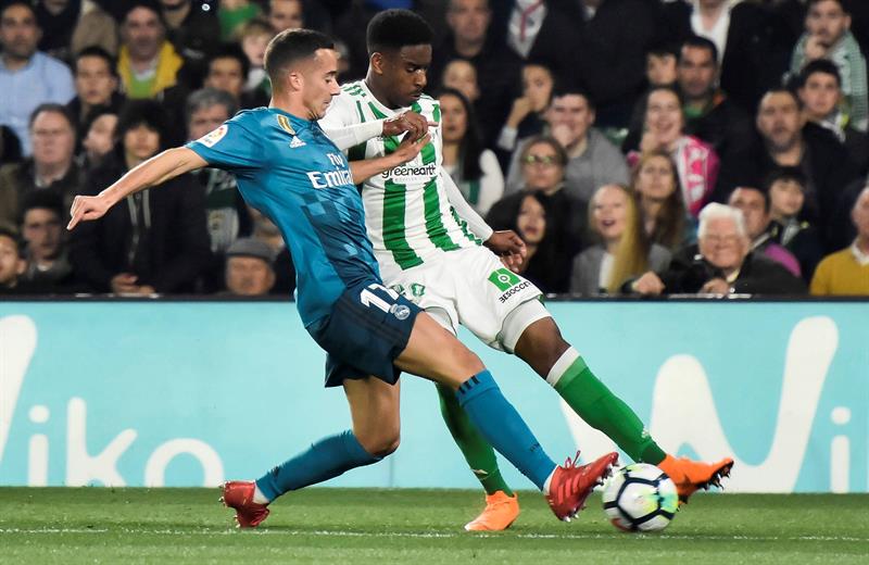 El defensa del Betis Júnior Firpo lucha el balón con Lucas Vázquez. Fuente: EFE/Raúl Caro